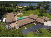 Expansive single-story home with a private pool and large yard overlooking a beautiful lake at 910 N Kepler Rd, Deland, FL 32724