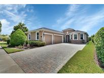 Charming, single-story home featuring a three-car garage, paved driveway, manicured landscaping, and stone accents at 1188 Eggleston Dr, Deland, FL 32724