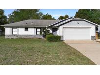 Charming single-story home with attached garage and well-maintained front lawn at 1627 Alloway Dr, Deltona, FL 32738
