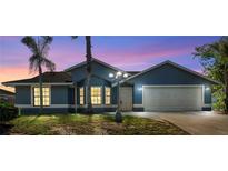 Charming blue single-story home with a two-car garage and manicured front lawn at 1842 W Cooper Dr, Deltona, FL 32725