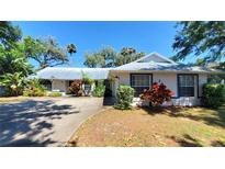 Charming single story home with a metal roof, mature landscaping, and a well maintained front yard at 1927 Orange Tree Dr, Edgewater, FL 32141