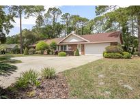 Charming single-story brick home with well-manicured landscaping and an inviting circular driveway at 2271 Springs Landing Blvd, Longwood, FL 32779