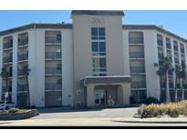 Multi-level condo building showing main entrance and black iron balconies at 2626 S Atlantic Ave # 1080, Daytona Beach, FL 32118