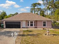 Charming single-story home featuring a two-car garage, well-maintained lawn, and decorative fountain at 3109 Sky St, Deltona, FL 32738