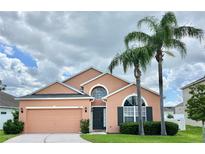 Charming one-story home with a well-manicured lawn and inviting curb appeal with beautiful palm trees at 320 Conch Key Way, Sanford, FL 32771