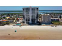 Stunning aerial view of beachfront condo building with private beach access and pool at 3855 S Atlantic Ave # 405, Daytona Beach, FL 32118