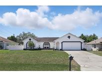 Charming single-story home with a well-maintained lawn and a two-car garage at 417 Jeffers St, Deltona, FL 32725