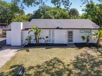 Charming single-story home with a white exterior, tidy landscaping, and a well-maintained lawn at 5400 Turton Ln, Port Orange, FL 32127