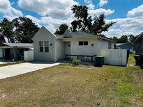 Charming single-story home featuring stucco siding, a neatly kept lawn, and a welcoming front porch at 606 W Voorhis Ave, Deland, FL 32720