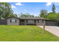 Charming single-story home with a well-manicured lawn and neutral brick facade at 795 Superior St, Deltona, FL 32725