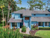 Inviting two-story home with a well-manicured lawn and lush landscaping at 161 Blue Heron Dr # C, Daytona Beach, FL 32119