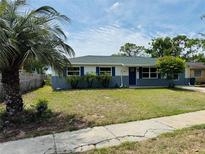 Charming single-story home with a well-maintained lawn, blue shutters, and a beautiful palm tree in the front yard at 1808 Green Pl, Ormond Beach, FL 32174