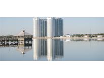 Scenic view of waterfront condos, reflecting on the water, with a gazebo in the foreground at 241 Riverside Dr # 902, Holly Hill, FL 32117