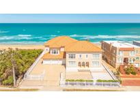 Stunning oceanfront home with a private sandy beach, garage, and white picket fence at 33 Ocean Shore Blvd, Ormond Beach, FL 32176