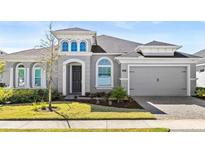 Charming single-Gathering home featuring a well-manicured lawn and a two-car garage at 617 Mosaic Blvd, Daytona Beach, FL 32124