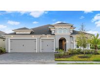 Beautiful single-story home featuring a paved driveway and a 3-car garage at 633 Mosaic Blvd, Daytona Beach, FL 32124