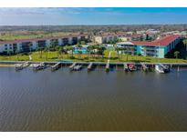 Waterfront condo complex featuring boat docks, lush landscaping, and a community pool with views of the Halifax River at 719 S Beach St # 302B, Daytona Beach, FL 32114
