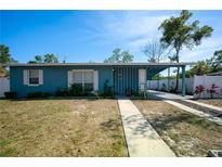 Charming single-story home with blue exterior, covered entry and walkway, and drought resistant landscaping at 925 Halstead St, Deltona, FL 32725