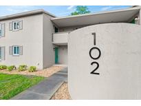 Inviting condo exterior featuring a well-maintained facade, lush landscaping, and clearly visible unit number 102 at 102 Bob White Ct # 102C, Daytona Beach, FL 32119