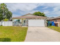 Charming single-story home with stone accents, a two-car garage, and a well-manicured lawn at 1343 Rocky Rd, Kissimmee, FL 34744