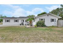 Charming single-story home with a well-maintained lawn, arched entrance, and colorful flower beds in the front yard at 1590 Urbana Ave, Deltona, FL 32725