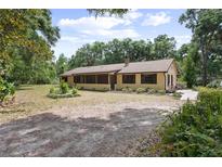 Charming single-story home with lush landscaping and a long driveway at 1690 S Adelle Ave, Deland, FL 32720