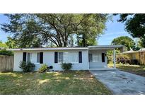 Charming single-story home featuring black shutters, covered entryway, and a well-maintained front yard at 175 Center St, Daytona Beach, FL 32117