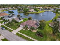 Stunning aerial view of home overlooking a lake with a fountain and well-manicured landscaping at 1860 Forough Cir, Port Orange, FL 32128