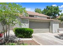 Charming home exterior featuring a two-car garage and well-maintained landscaping in a suburban neighborhood at 207 Pine Cone Trl, Ormond Beach, FL 32174