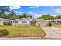 Charming single-story home featuring stone accents, attached garage, and well-maintained front yard at 2144 Brian Ave, South Daytona, FL 32119