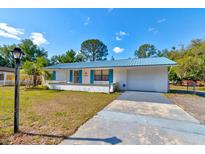 Charming single-story home with a blue metal roof and well-maintained landscaping at 2214 Danforth Ave, Deltona, FL 32738