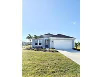 Charming single-story home with manicured lawn, two-car garage and welcoming entrance at 4133 Gilford Cir, Ormond Beach, FL 32174