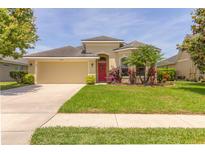 Charming one story home with a well-manicured lawn and colorful landscaping at 6917 Vintage Ln, Port Orange, FL 32128