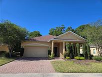 Charming single-story home with a brick driveway, well-kept lawn, and manicured landscaping at 139 Crawl Key Ct, Deland, FL 32720