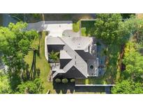 Aerial view of a well-maintained home featuring a long driveway and manicured lawn at 1523 Red Plum Holw, Deland, FL 32720