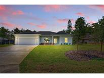 Charming single story home with a well-manicured lawn and neutral paint at 156 N Cory Dr, Edgewater, FL 32141