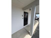 View of the condo's front door numbered '1' and its exterior features at 2101 N Atlantic Ave # 10, Daytona Beach, FL 32118