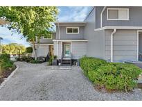 Charming gray townhouse featuring a landscaped front yard and inviting front entrance at 2329 River Ridge Rd # 4, Deland, FL 32720