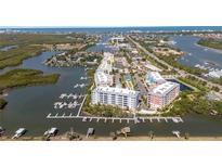 Stunning aerial view of waterfront condos and boat docks on the Florida coast at 3 Riverwalk Dr # 202, New Smyrna Beach, FL 32169