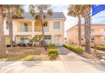 Charming two-story townhome with inviting curb appeal and lush, tropical landscaping at 3733 Cardinal Blvd # 1, Daytona Beach, FL 32118