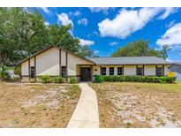 Charming single-story home with manicured landscaping and a welcoming walkway leading to the entrance at 5788 Devon St, Port Orange, FL 32127