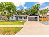 Charming single-story home with modern design, fresh landscaping, and a spacious driveway at 612 Moonpenny Cir, Port Orange, FL 32127