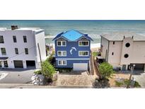 Charming blue beachfront home with a metal roof and an ocean view at 6847 S Atlantic Ave, New Smyrna Beach, FL 32169