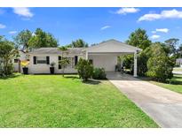 Charming single-story home with a well-maintained lawn and a covered carport at 708 Wayne Ave, New Smyrna Beach, FL 32168