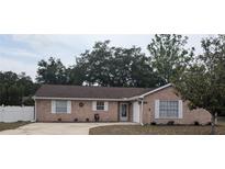 Charming single-story brick home featuring a well-maintained front yard and attached garage at 1250 Lemonwood Ave, Deland, FL 32724