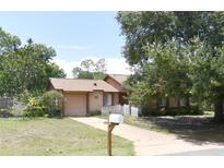 Charming single-story home with a driveway, lawn, and mature trees offering shade at 132 Wax Myrtle Ct, Sanford, FL 32773