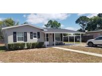 Charming single-story home featuring a covered front porch and well-maintained landscaping at 1626 S Page Dr, Deltona, FL 32725