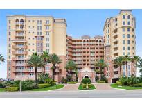 Elegant condo building with manicured landscaping, and a covered entrance, for a luxurious residential experience at 2515 S Atlantic Ave # 1001, Daytona Beach Shores, FL 32118