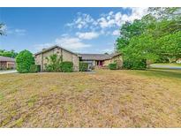 Charming single-story home featuring stone accents, mature landscaping, and a well-maintained yard at 2704 Burgoyne Pl, Deland, FL 32720