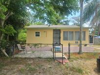 Charming single-story home with a fenced yard, walkway, and mature landscaping at 317 Inwood Ave, New Smyrna Beach, FL 32168